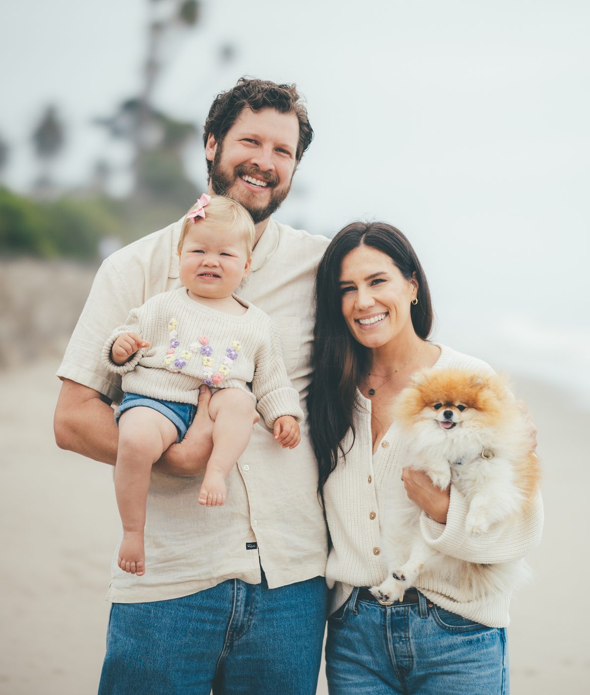 The Russell family on the beach: Sean holding Willa, Mandi holding Winnie