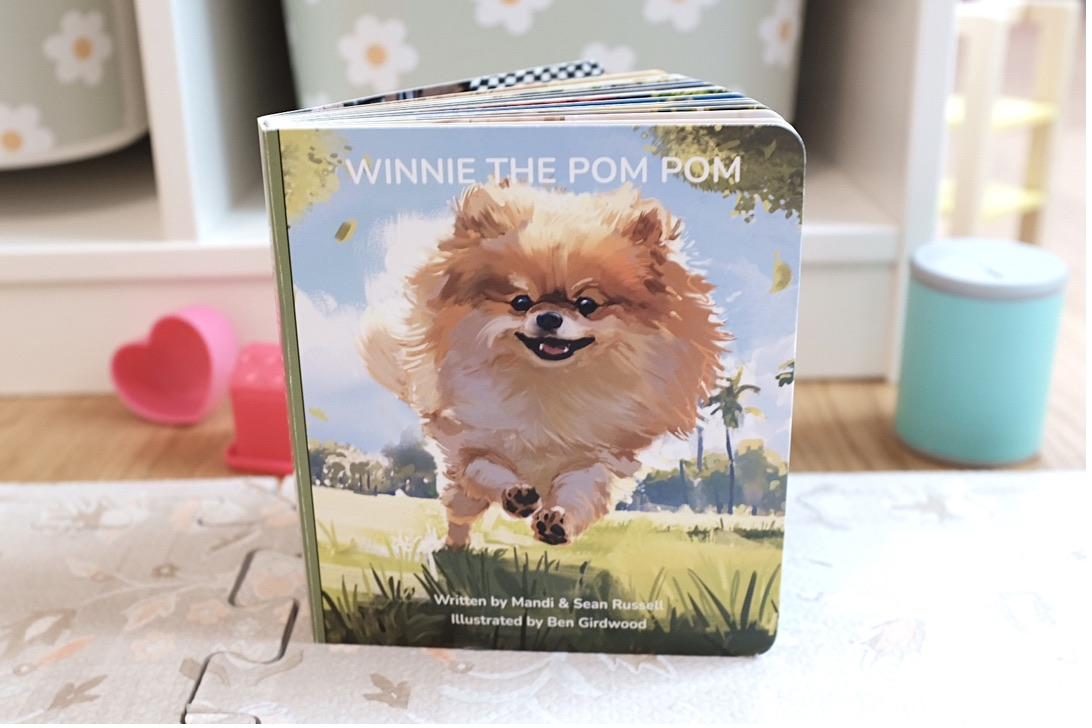 The printed Winnie the Pom Pom board book standing upright